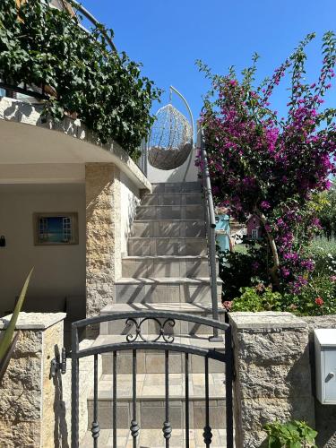 a staircase leading up to a house with flowers at ILOVIK FLOWER in Ilovik