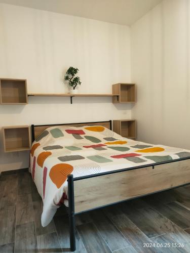 une chambre avec un lit avec une couette dessus dans l'établissement Charmant et cosy 200m de port, à La Ciotat