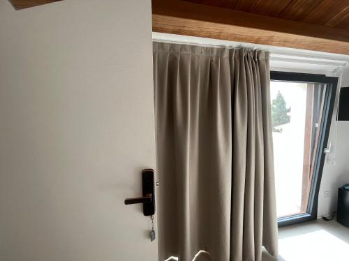 a curtain in a room with a window at Tenuta Rapillo in Castellammare del Golfo