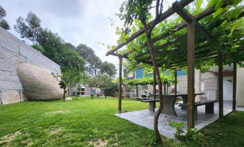 a garden with a picnic table and a building at CASA D´PEPE in Meis