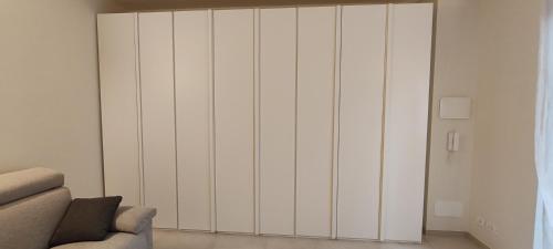a white cabinet in a living room with a couch at Bordighera Castello Selva Dolce in Bordighera