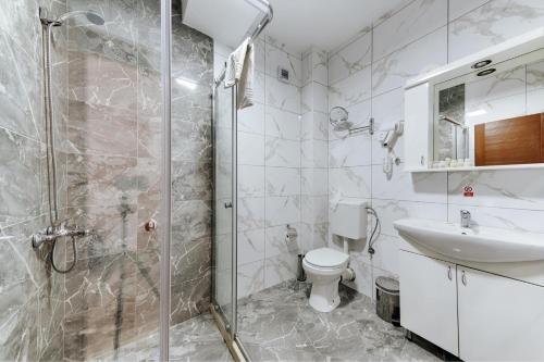 a bathroom with a shower and a toilet and a sink at Hotel &Scaron;ARS in Dobra Voda