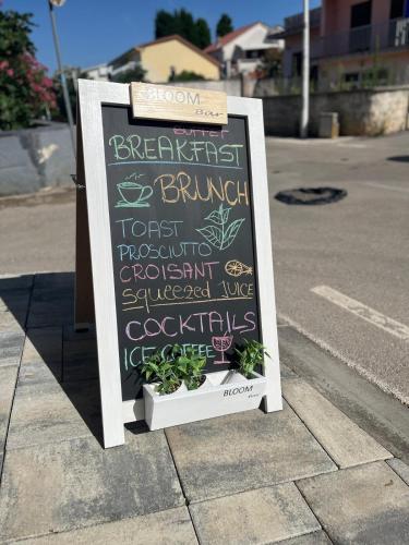 a sign sitting on the side of a street at B&B Bloom Apartments in Vir