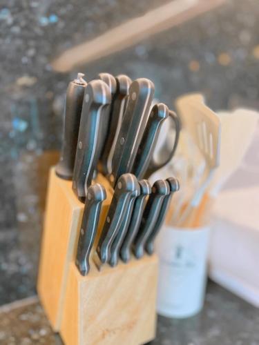 a wooden block of knives sitting on a table at PNT LUXURY JOMTIEn in Jomtien Beach