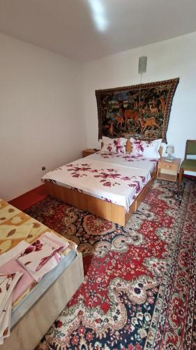 a bedroom with two beds and a rug at Casa Lidia in Jurilovca
