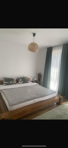 a bedroom with a large bed and a ceiling at Casa Mai in Vişeu de Sus