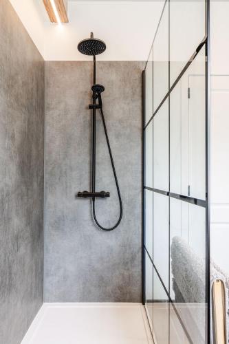 a shower in a bathroom with a glass wall at Domein Den Buiten Bed And Breakfast DnD in Sint-Niklaas