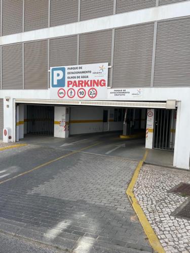 a parking lot with a parking sign in front of a building at Varanda para o Mar in Albufeira
