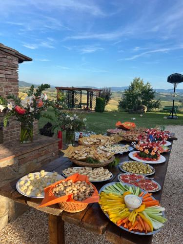 a table with many plates of food on it at Agriturismo Casallario in Volterra