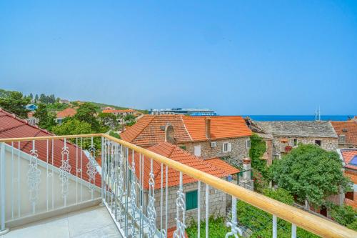 a view from the balcony of a house with roofs at Hotel Brattia, Adults Only, Heated Pool, A la Carte Breakfast, Postira, Brač Island in Postira
