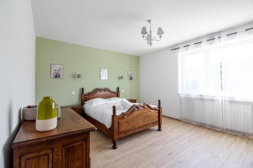 a bedroom with a bed and a table and a window at Sweet-Pastel in Cattenom