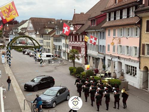 a group of military personnel walking down a city street at Family M Apartments 16-17-18 in Sempach