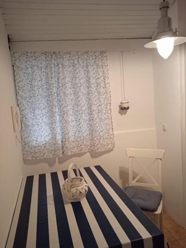 a bedroom with a bed with a blue and white curtain at Apartment Vinko in Šibenik