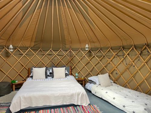 a couple of beds in a yurt at Nordic Glamping at Botswicky - a nature based retreat in Bishopstone