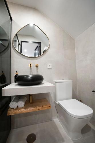 a bathroom with a sink and a mirror at La morada de Rosafina in Frigiliana