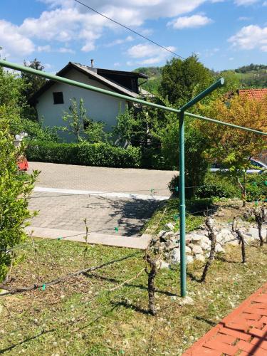 a green street light in a yard with a house at House Laganini Grill & Relax in Sveti Križ