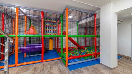 a play room with colorful play equipment in it at Apartament Diuna in Krynica Morska