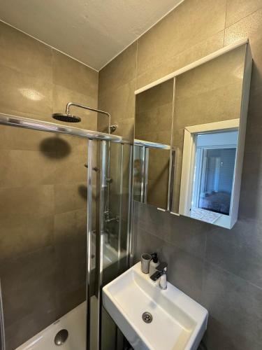 a bathroom with a sink and a shower at HOUSE IVY - next to Marina Hramina in Murter