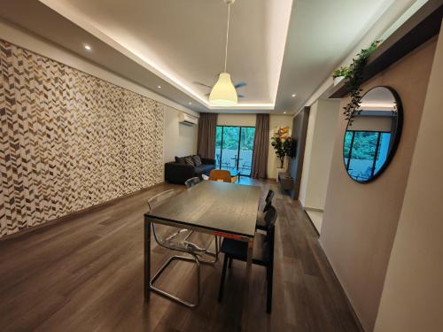 a living room with a table and a couch at Cosy Designer's Home By The Mountain in Lumut