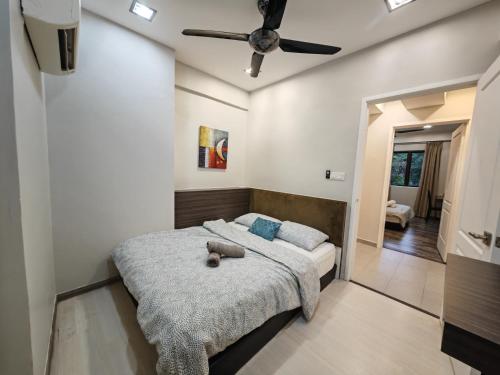 a bedroom with a bed and a ceiling fan at Cosy Designer's Home By The Mountain in Lumut