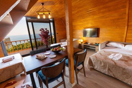 a bedroom with a bed and a table in a room at Galaxy Bungalow in Trabzon
