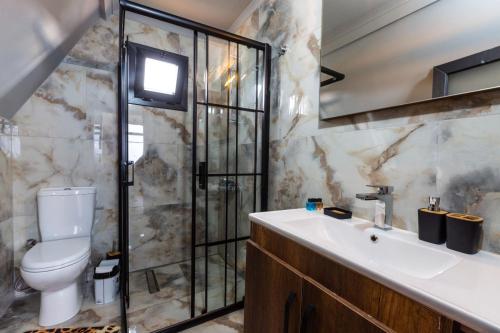 a bathroom with a toilet and a sink at Galaxy Bungalow in Trabzon