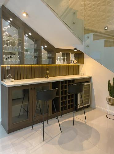 a kitchen with a counter and two stools at Apartment in Jahi, Abuja in Jahi