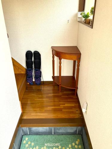 a hallway with a desk and a table and chairs at 秋田ゲストハウス　BASE464 in Akita