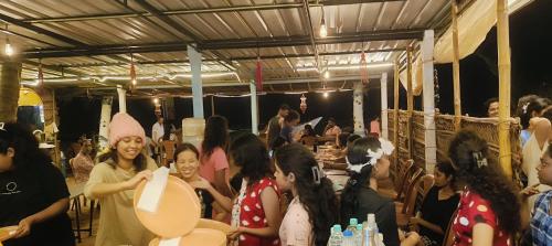 a group of people standing around in a room at Srujana Beach Homestay in Gokarn