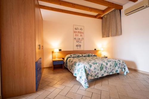 a bedroom with a bed and a dresser and two lamps at Agriturismo Mazzeracca in Bassano del Grappa