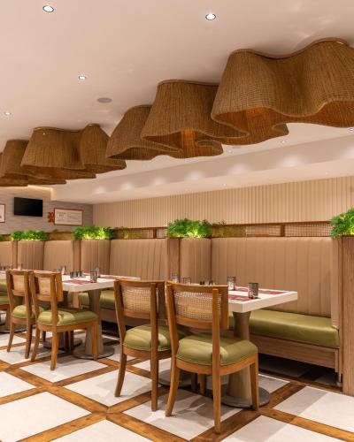 a dining room with tables and chairs in a restaurant at Copper Leaf Hotels, Tirunelveli in Tirunelveli