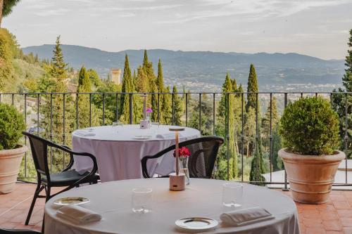 a table and chairs on a balcony with a view at FH55 Hotel Villa Fiesole in Fiesole