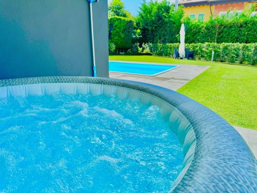 a swimming pool in a yard next to a house at LHV Garda Lake - Private POOL and SPA in Bardolino