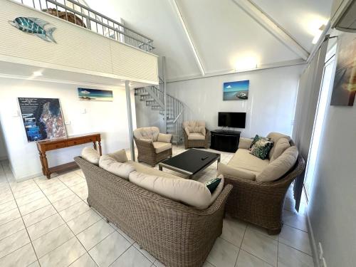 a living room with two couches and a table at Osprey Holiday Village Unit 108 in Exmouth