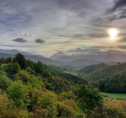 a view of a valley with a river and mountains at BnB Bagno di Bosco in Gubbio