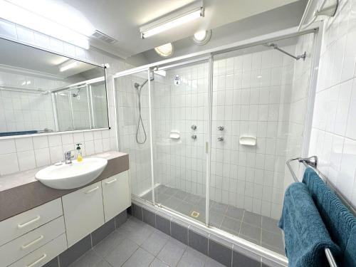 a bathroom with a glass shower and a sink at Osprey Holiday Village Unit 108 in Exmouth
