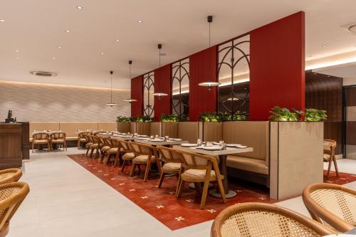 a dining room with tables and chairs at Copper Leaf Hotels, Tirunelveli in Tirunelveli