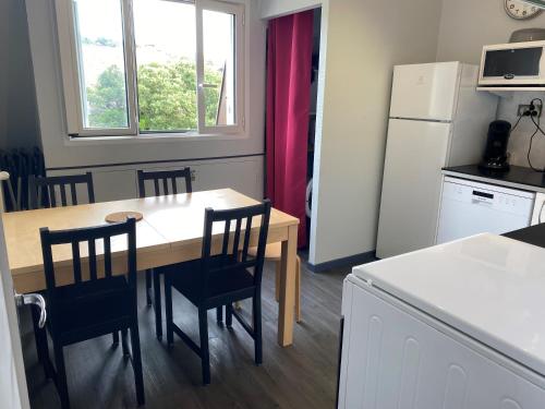 une cuisine avec une table, des chaises et un réfrigérateur dans l'établissement Appartement Pour 6 Personne- Residence San Michele, à Hossegor