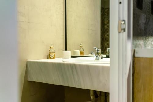a bathroom with a white sink and a mirror at The Dorians in Athens