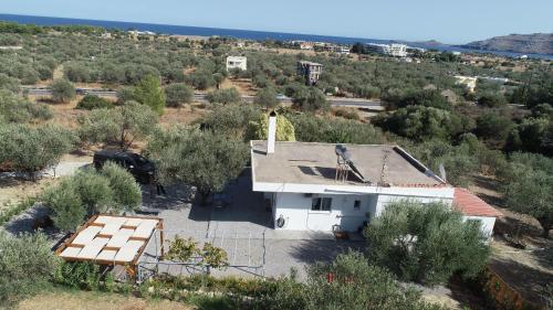 an aerial view of a white building with a roof at Evgenias Olive House in Kalathos