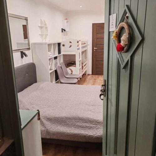 a room with a bedroom with two beds and a chair at Silver Apartments in Bogács