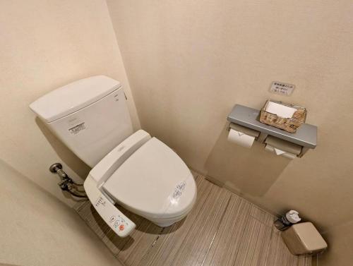 a bathroom with a white toilet in a room at もしもしピエロ 泉大津新館 in Izumiotsu
