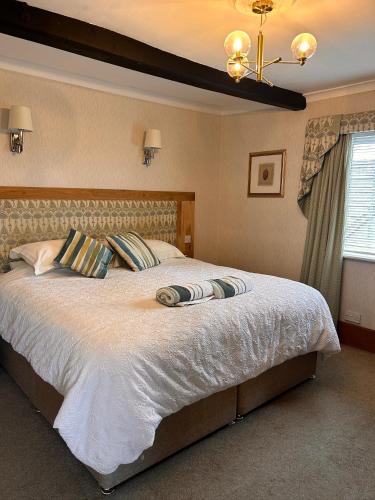 a bedroom with a large bed with white sheets at Henwick house accommodation, Continental breakfast included in Ludlow