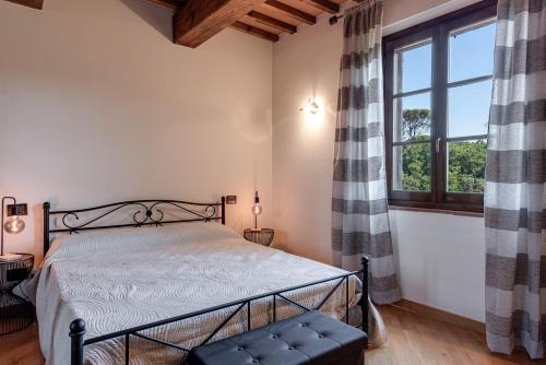 a bedroom with a bed and a window at Fattoria Antinoro Relax - Firenze in Montelupo Fiorentino