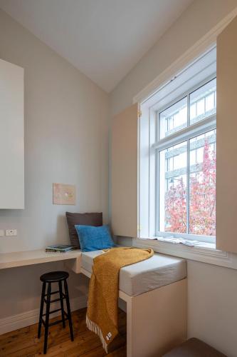 a small room with a bed and a window at The Princes Apartment in Dunedin