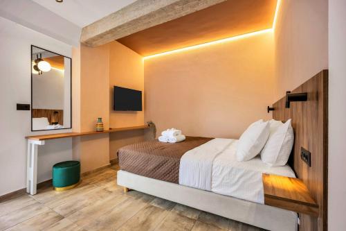 a hotel room with a bed and a mirror at The Dorians in Athens