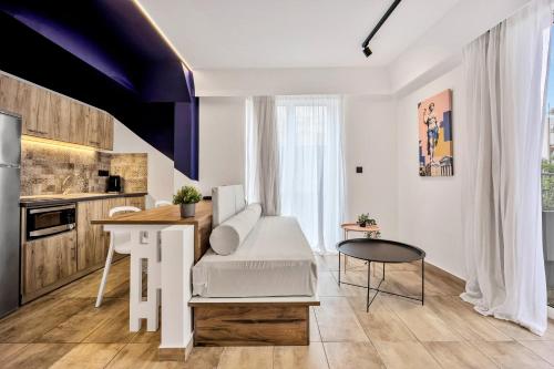 a living room with a table and a kitchen at The Dorians in Athens