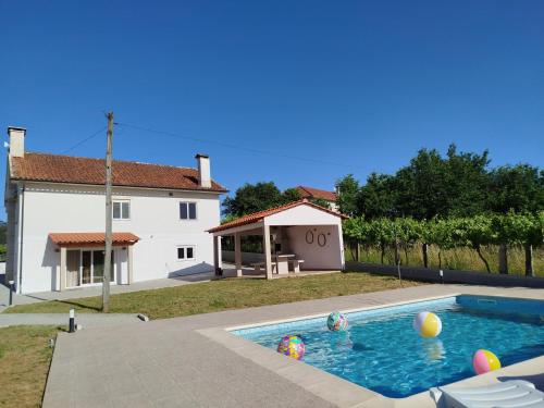 a swimming pool in front of a house at Casinha da Glória in Silva
