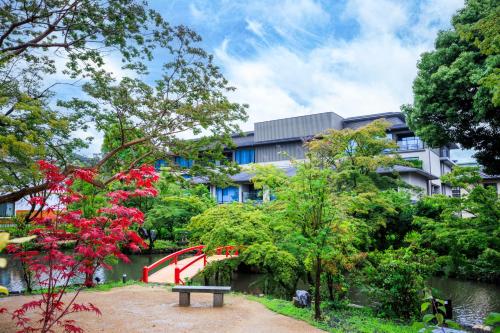 a building with a red slide in a garden at Hotel Okura Kyoto Okazaki Bettei in Kyoto