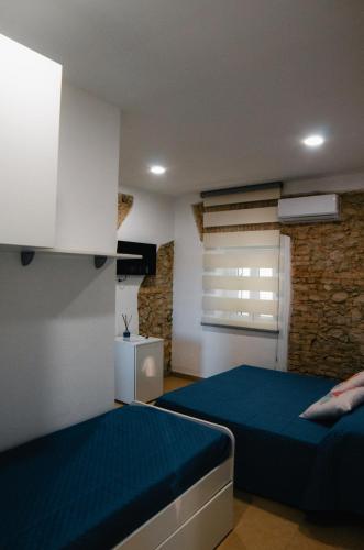 a bedroom with two beds and a window at Al Mare Fuori in Calopezzati